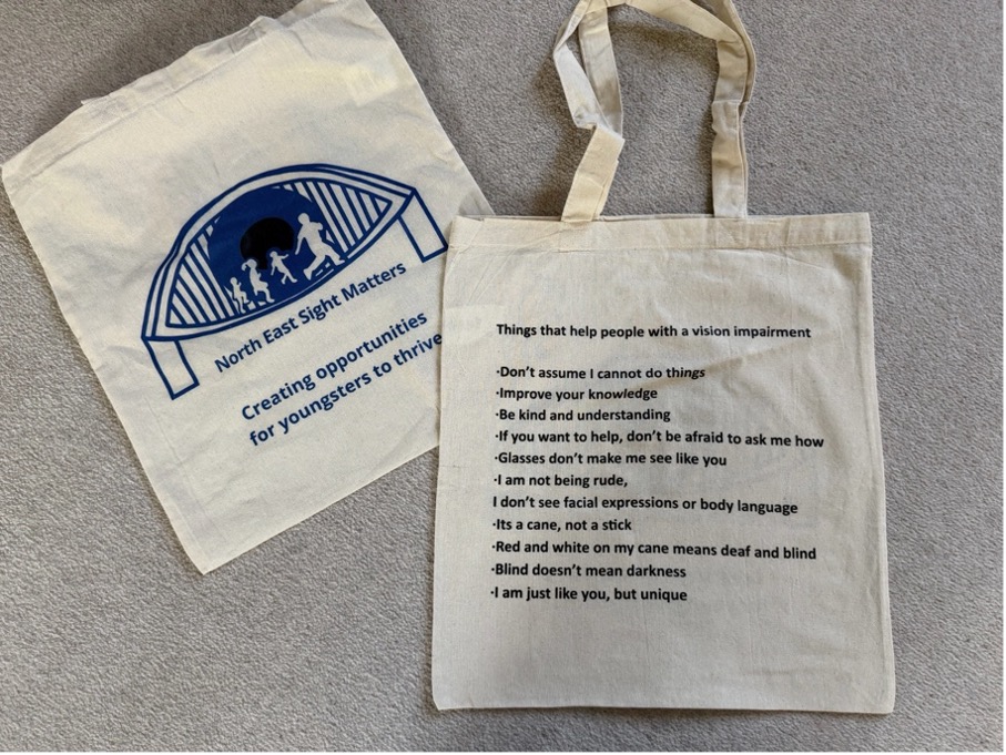 A tote bag with the bulleted list below printed on it.